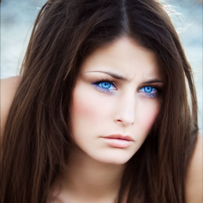 Close-Up of Woman with Striking Blue Eyes and Long Brown Hair