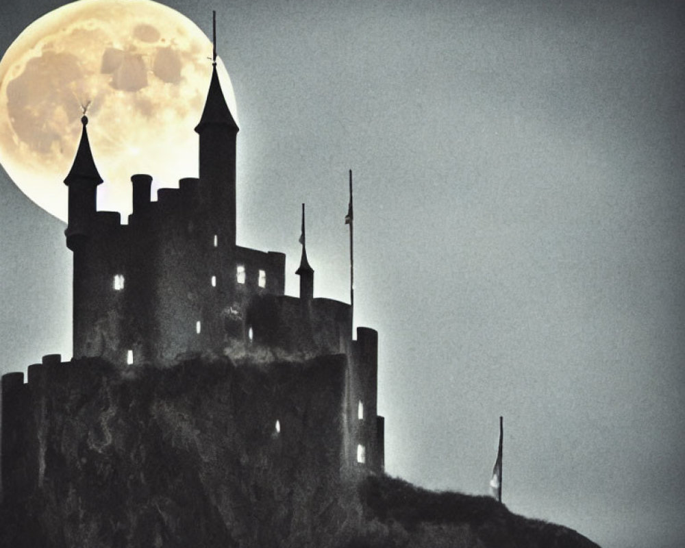 Silhouetted castle with turrets under full moon