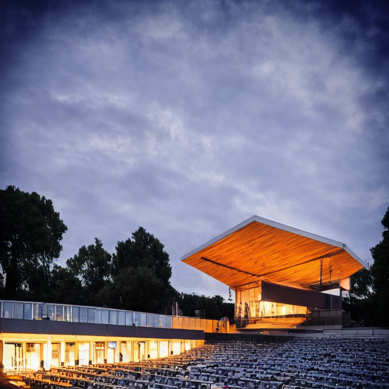 Outdoor Amphitheater with White Seats at Dusk and Overhanging Canopy