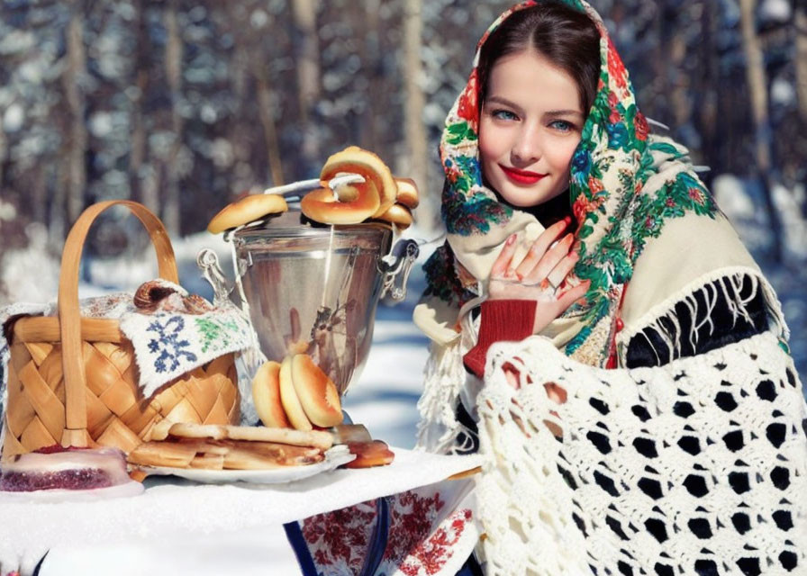 Traditional headscarf woman with samovar and food on snow-covered table