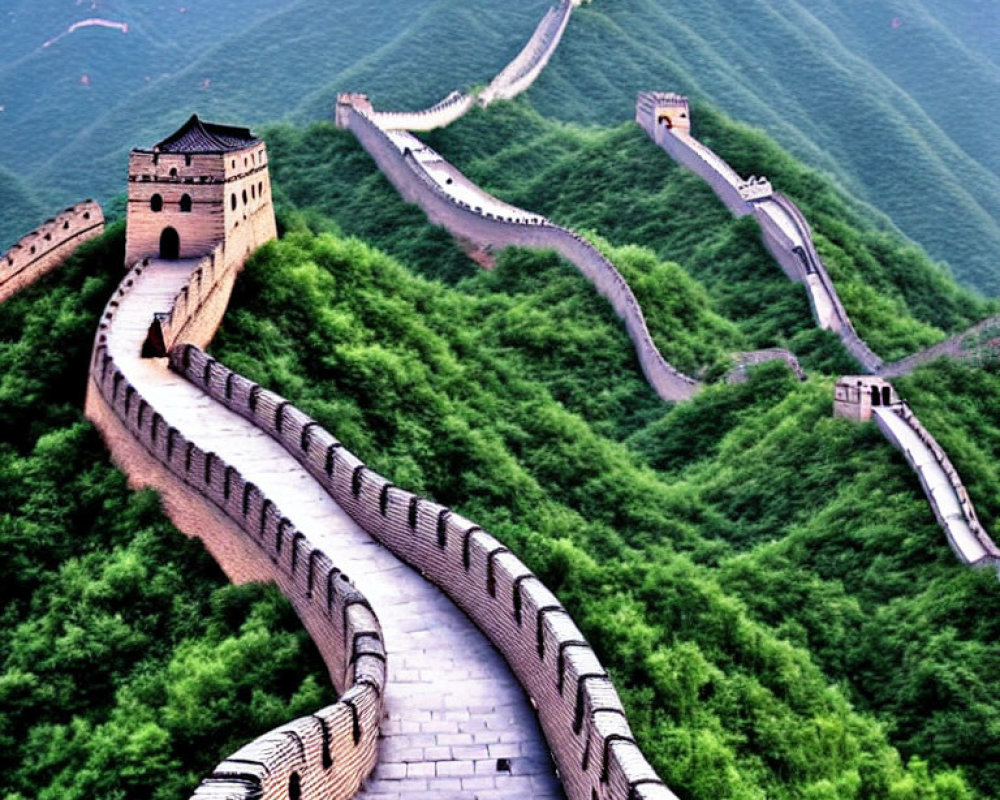 Iconic Great Wall of China in lush green hills under hazy sky