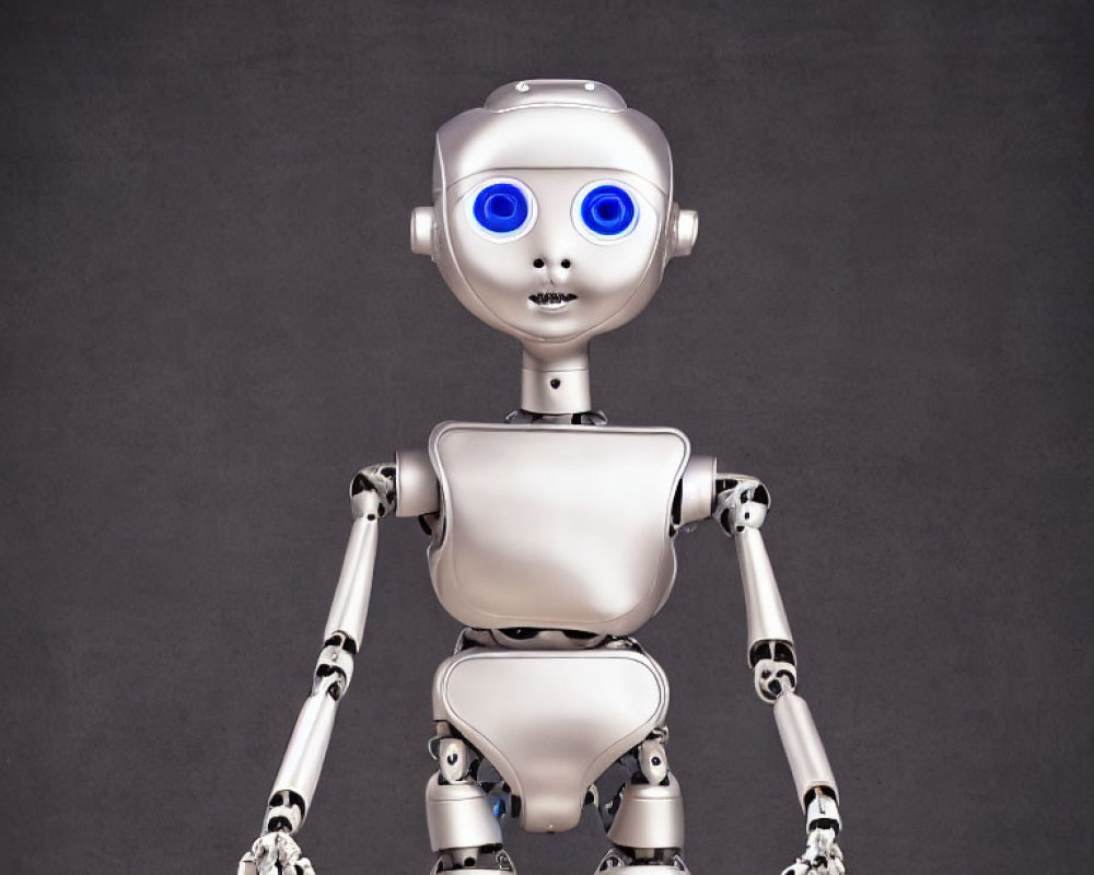 Silver humanoid robot with blue eyes on grey background