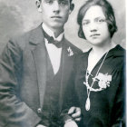 Elderly couple in vintage portrait: man in suit, woman in dark dress