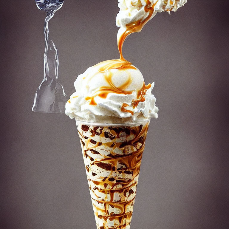 Melting caramel ice cream cone on gray background