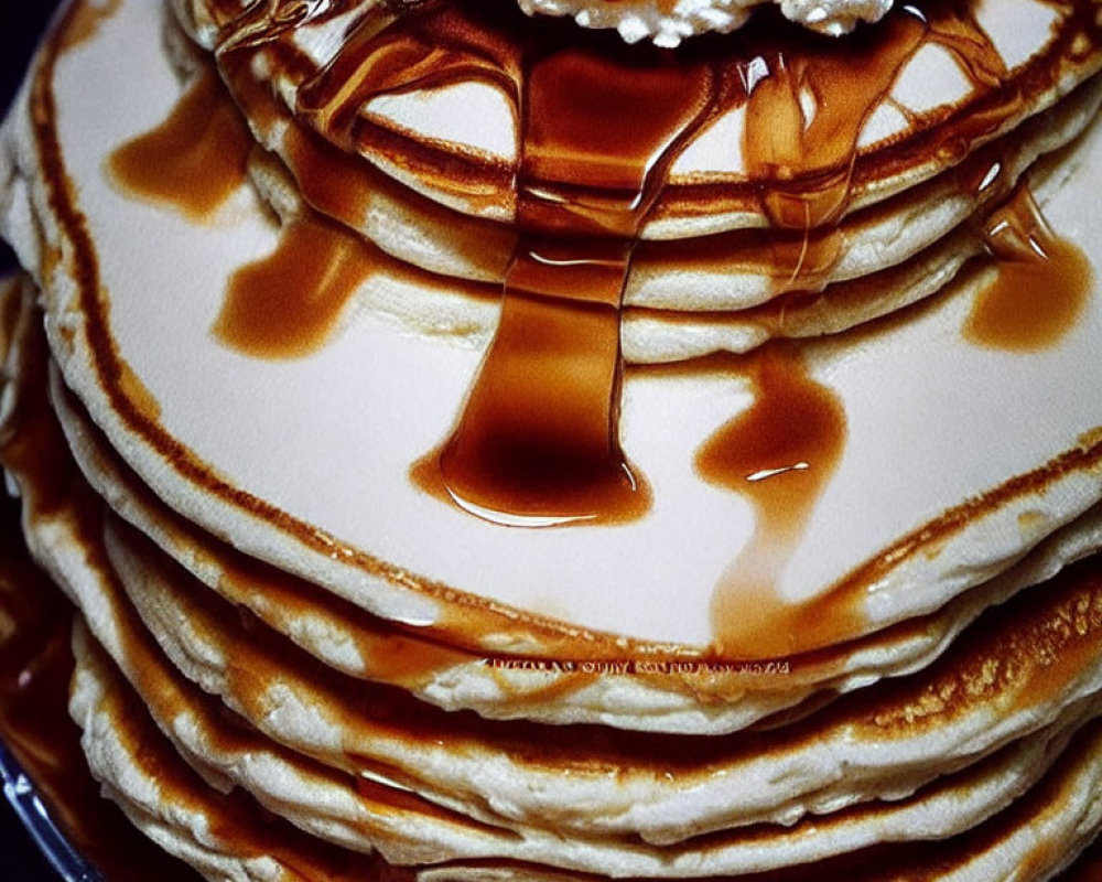 Golden Pancakes Stack with Whipped Cream, Butter, and Maple Syrup