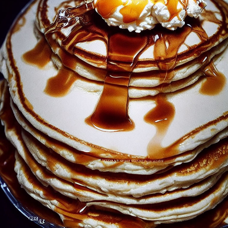 Golden Pancakes Stack with Whipped Cream, Butter, and Maple Syrup