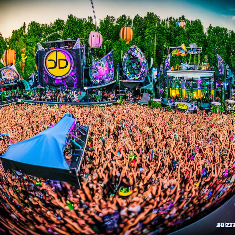 Colorful outdoor music festival scene with vibrant crowd and circular logo stage