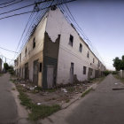 Desolate urban street with graffiti-covered buildings and debris