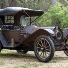 Rusted futuristic police car with advanced machinery in mystical greenery setting