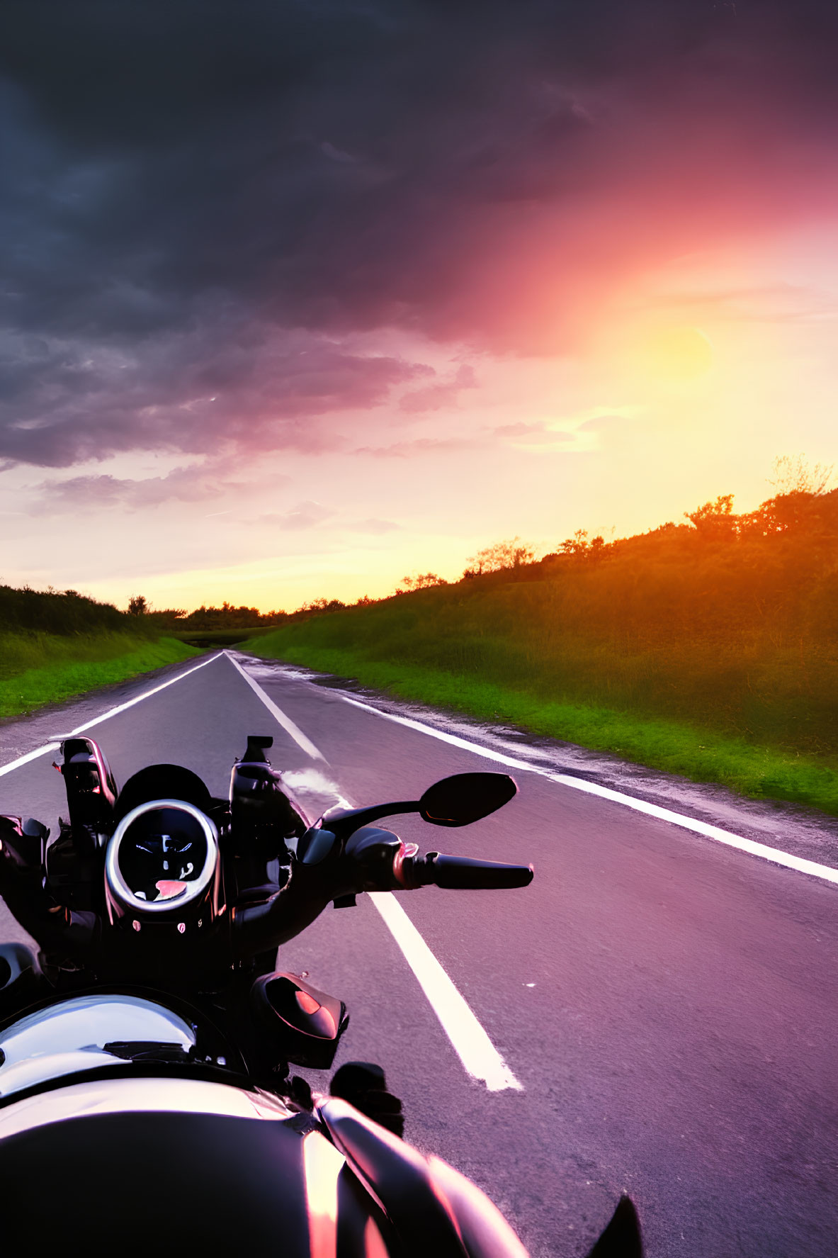 Motorcycle parked on road at sunset with vibrant pink and orange skies