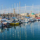 Vibrant Sunset Painting Over Marina with Boats & Reflections