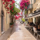 Charming cobblestone street with white buildings and outdoor dining scene