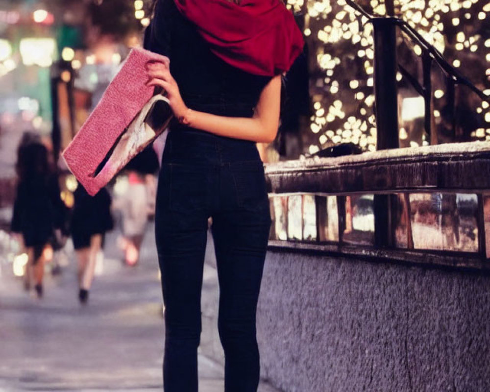 Woman standing on city sidewalk at night with clutch, bokeh street lights in background