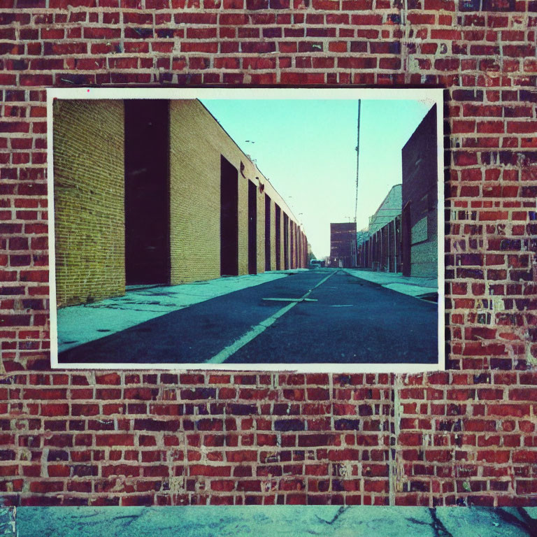 Urban alleyway photograph displayed on brick wall