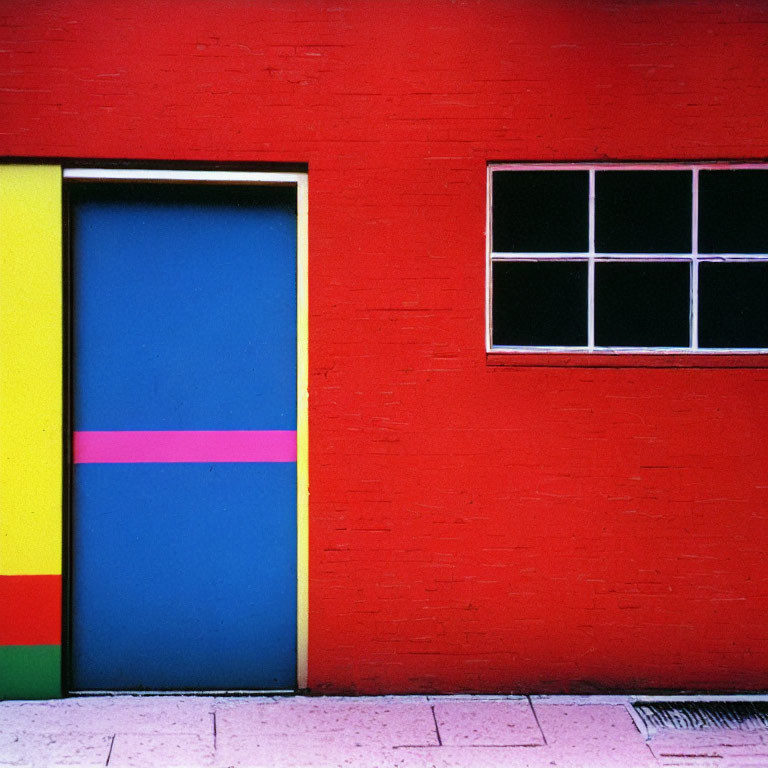 Colorful Striped Door Against Red Wall with White Window Frame