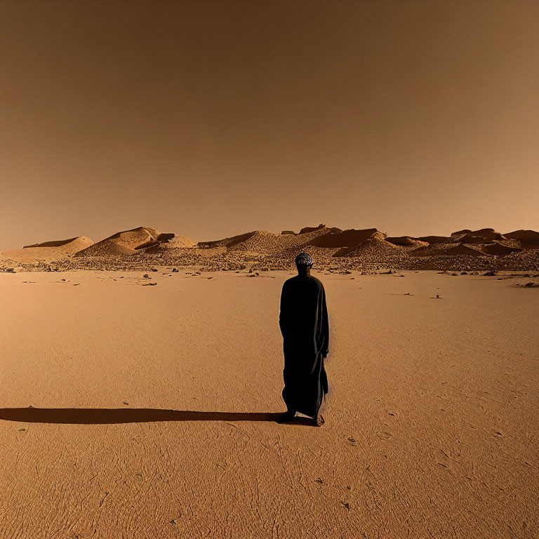 Robed figure on Mars-like desert landscape under amber sky