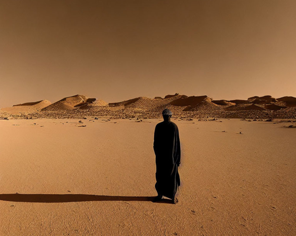 Robed figure on Mars-like desert landscape under amber sky