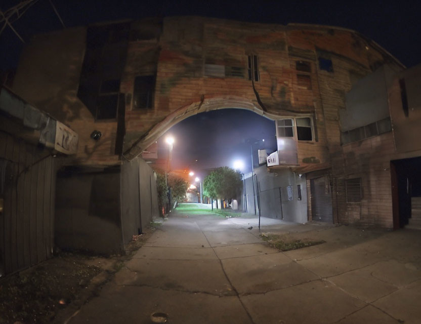 Dimly Lit Alley Night Scene with Arched Mural Building