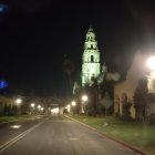 Deserted Street at Night with Graffiti and Lit Streetlamp