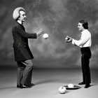 Adult and child juggling balls in front of each other