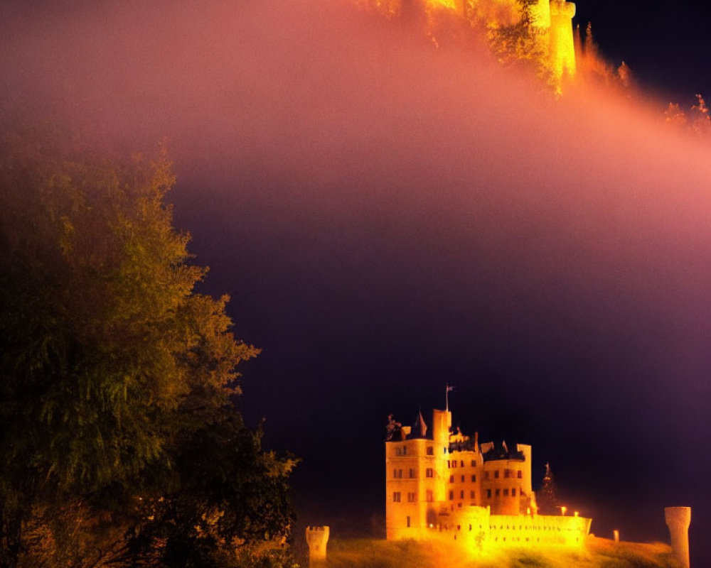 Majestic castle and hillside fortress illuminated in foggy night landscape