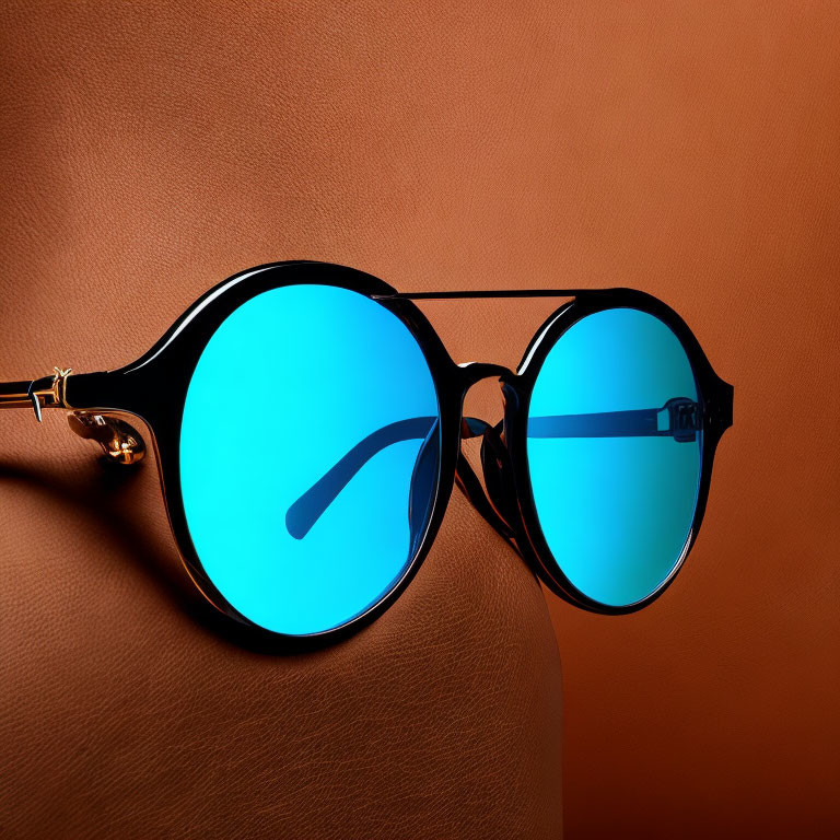 Blue Lens Sunglasses with Black Frames on Brown Background