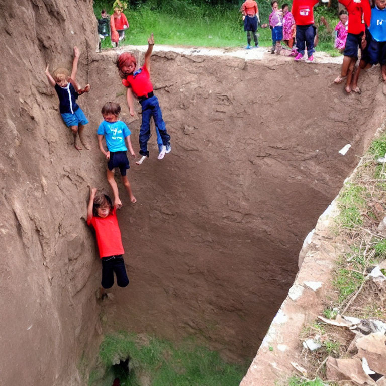 Kids climbing and playing in outdoor dirt ditch