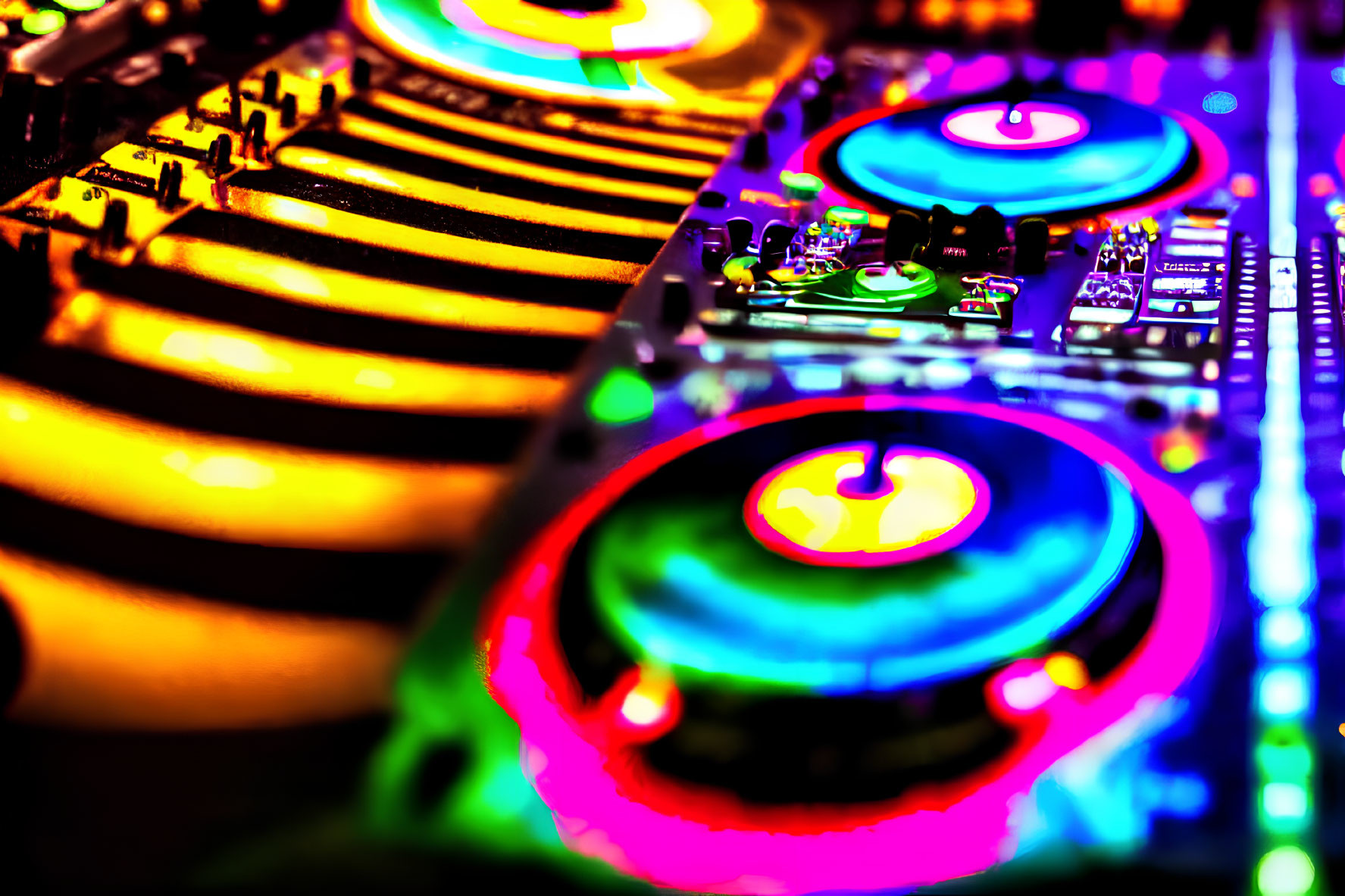 Neon-colored DJ mixing console with illuminated buttons and rotating turntable platters