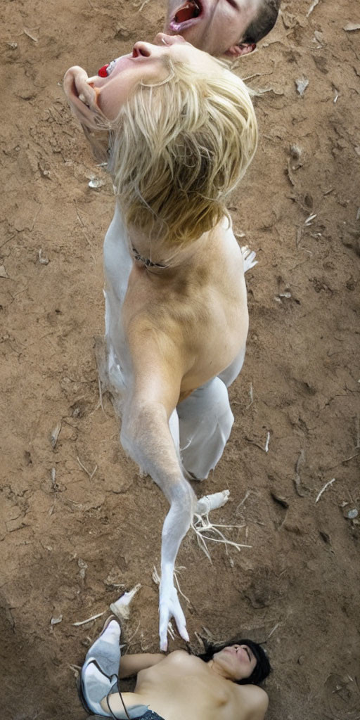 Three individuals lying on the ground in overhead view