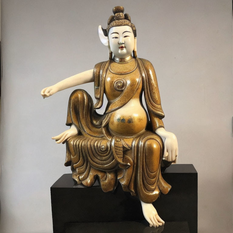 Serene Asian-inspired statue in flowing robes, seated gracefully.