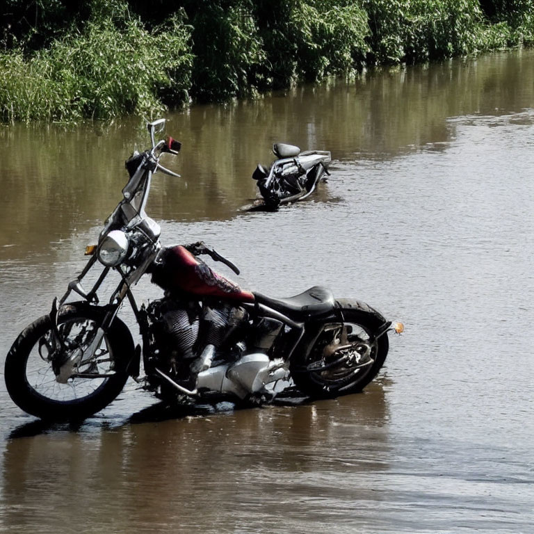 Two motorcycles in flooded area with trees in background