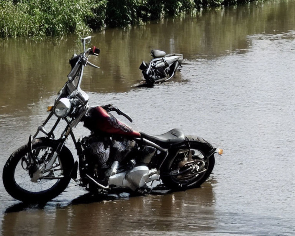 Two motorcycles in flooded area with trees in background