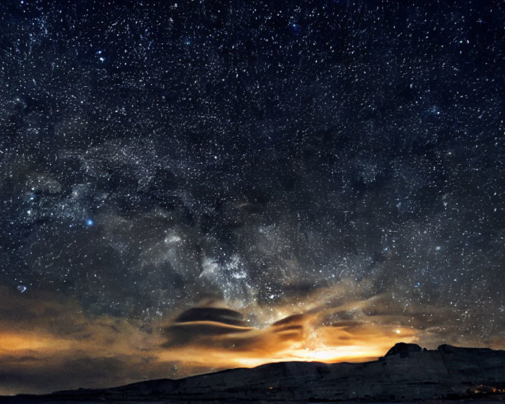 Starry Night Sky Silhouette of Mountain Range with Warm Glow