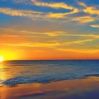 Scenic beach sunset with golden hues and calm waves