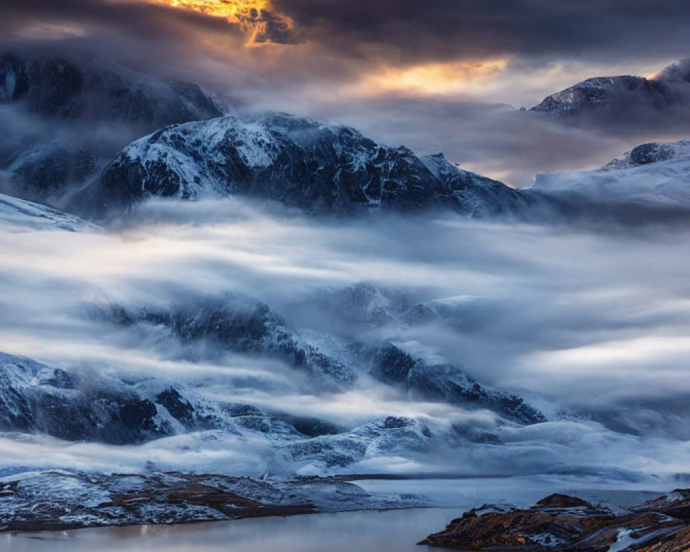 Sunlit Snow-Capped Mountains Reflecting in Tranquil Lake