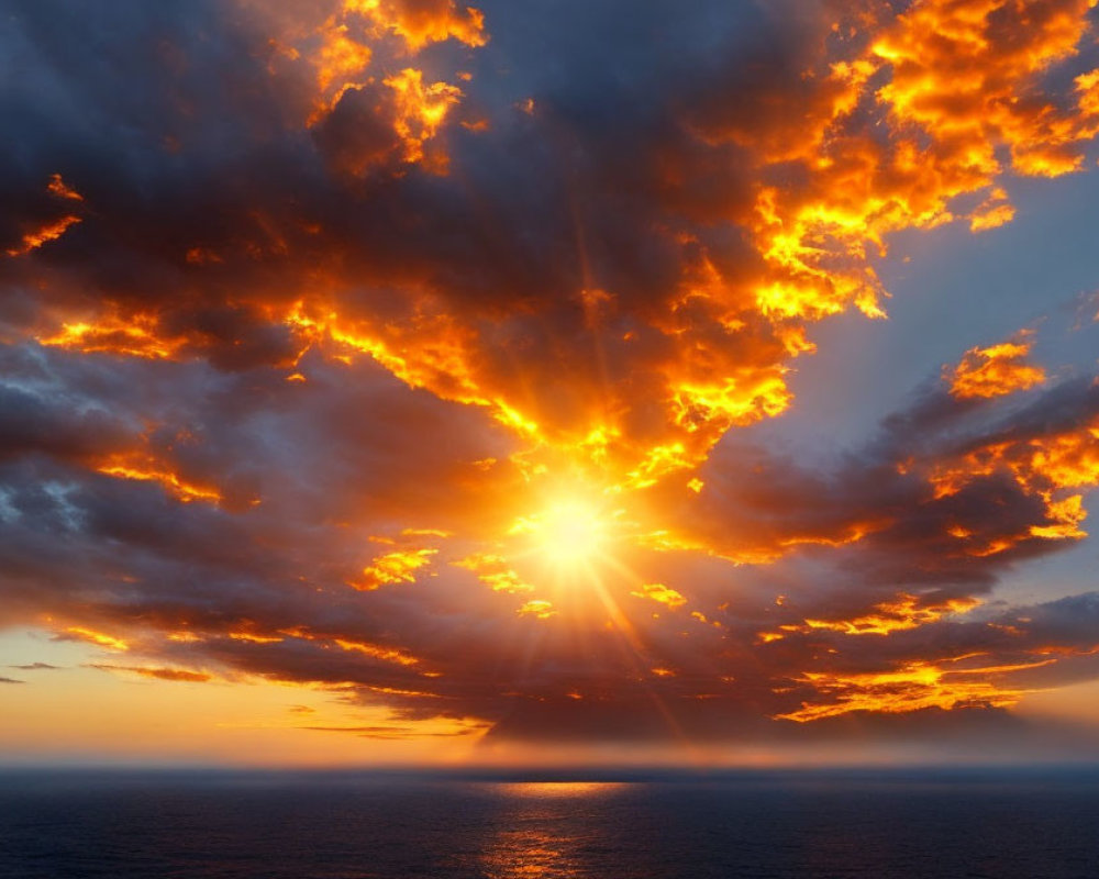 Dramatic Fiery Sunset with Sunbeams over Calm Sea