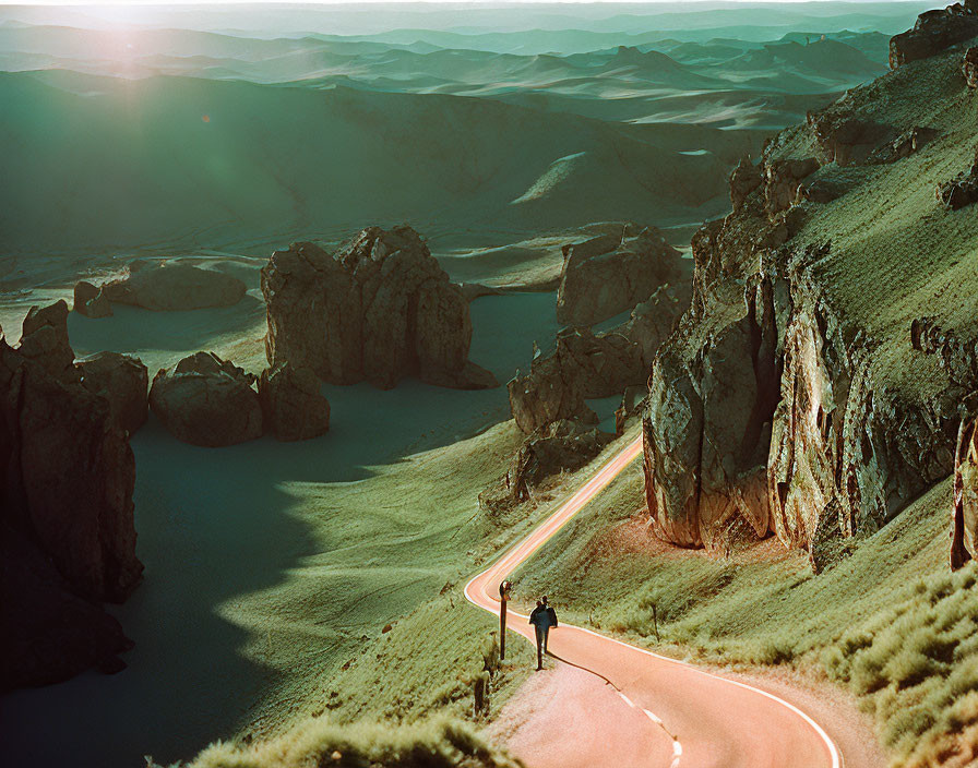 Desert landscape with lone traveler on meandering road