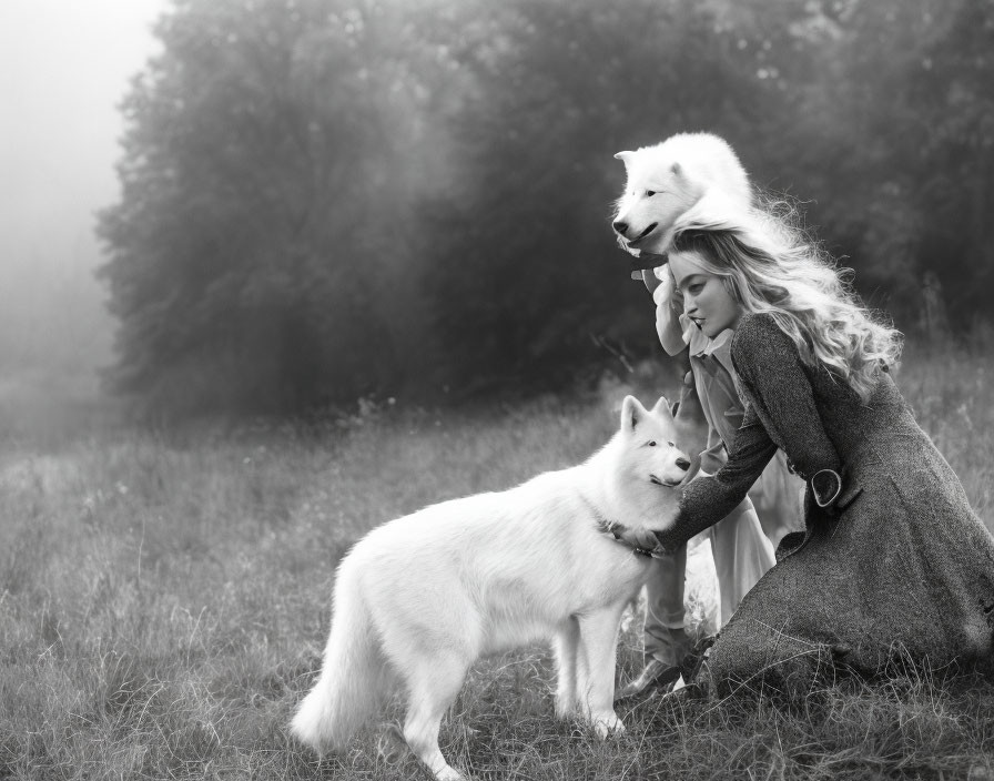 Woman in gray coat kneeling with two white dogs in misty field