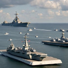 Navy fleet with aircraft carrier and support vessels at sea