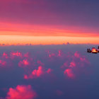 Twin jets flying in formation at sunset with pink and orange sky.