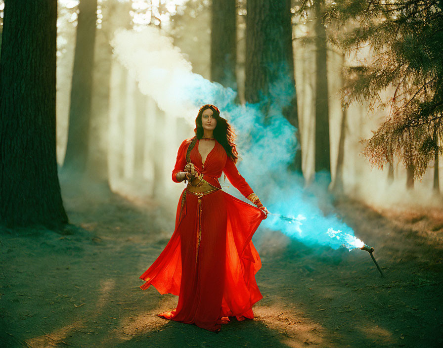 Person in vibrant red dress wields sword in mystical forest with swirling blue smoke