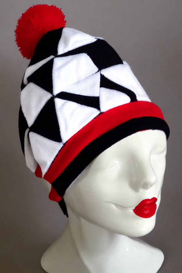 Monochrome Patterned Beanie with Red Pom-Pom and Trim on Mannequin Head