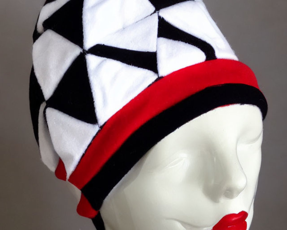 Monochrome Patterned Beanie with Red Pom-Pom and Trim on Mannequin Head