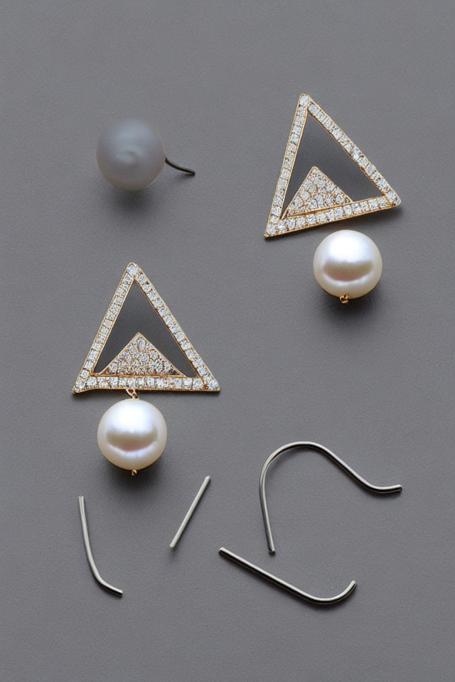 Pearl Earrings with Triangular Gold and Diamond Tops on Gray Background