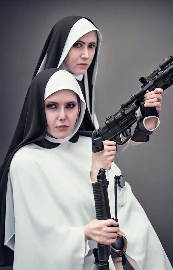 Two women in nun costumes with rifles, one standing behind the other, against a grey backdrop