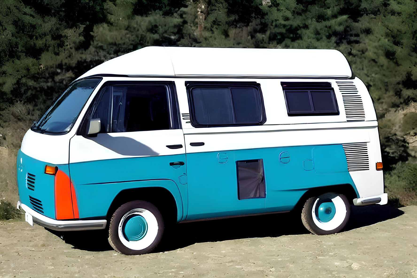 Blue and White Volkswagen Camper Van Outdoors with Natural Backdrop