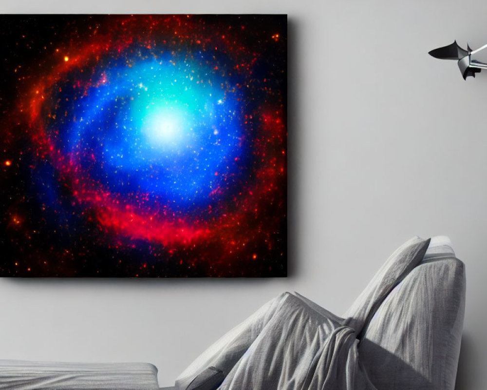 Colorful space-themed canvas above grey sofa with person's legs.