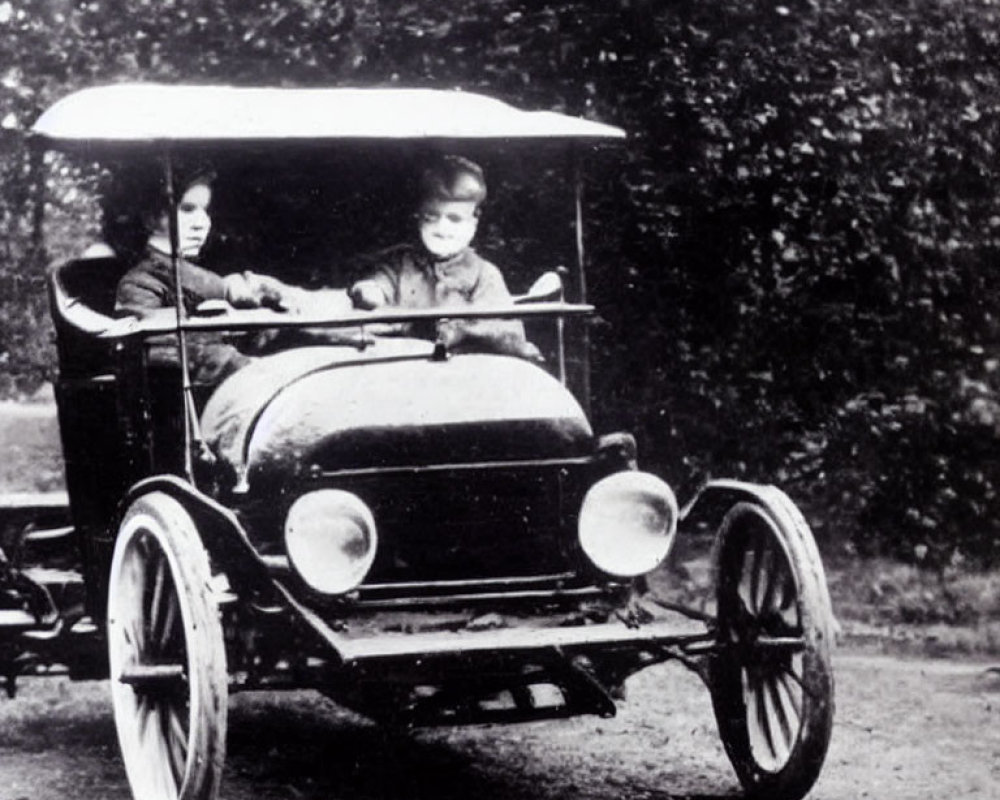 Vintage open automobile with round headlights on dirt road