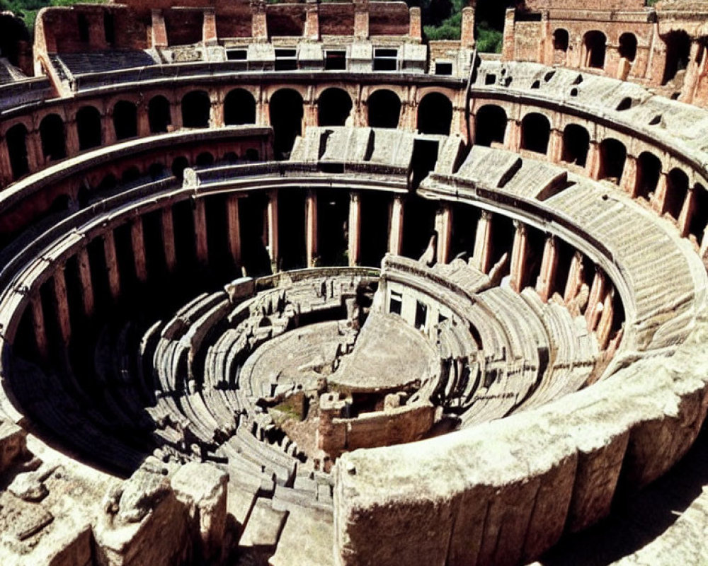 Ancient Roman Amphitheater with Arched Entrances and Weathered Stone Seating