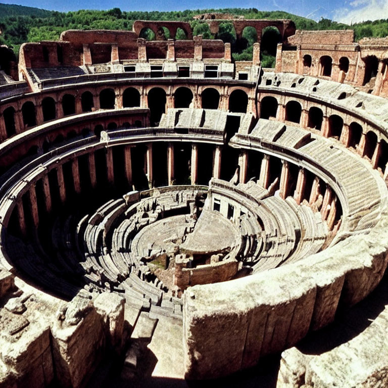 Ancient Roman Amphitheater with Arched Entrances and Weathered Stone Seating